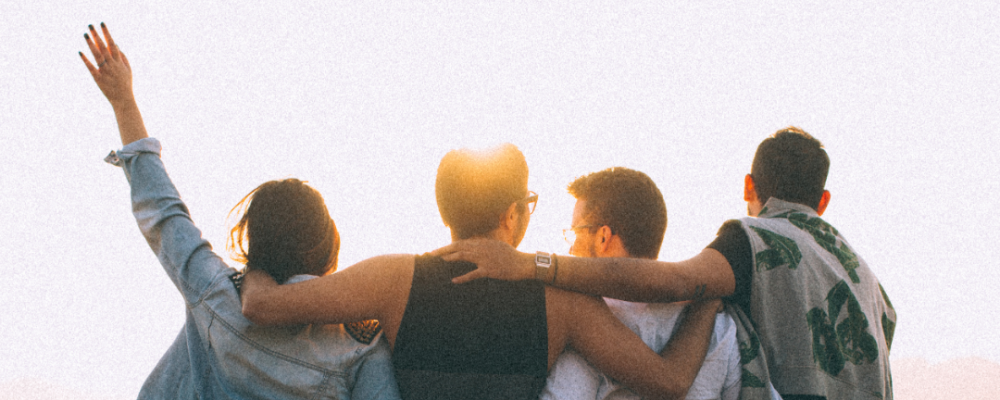 Group photo of friends looking toward the sun
